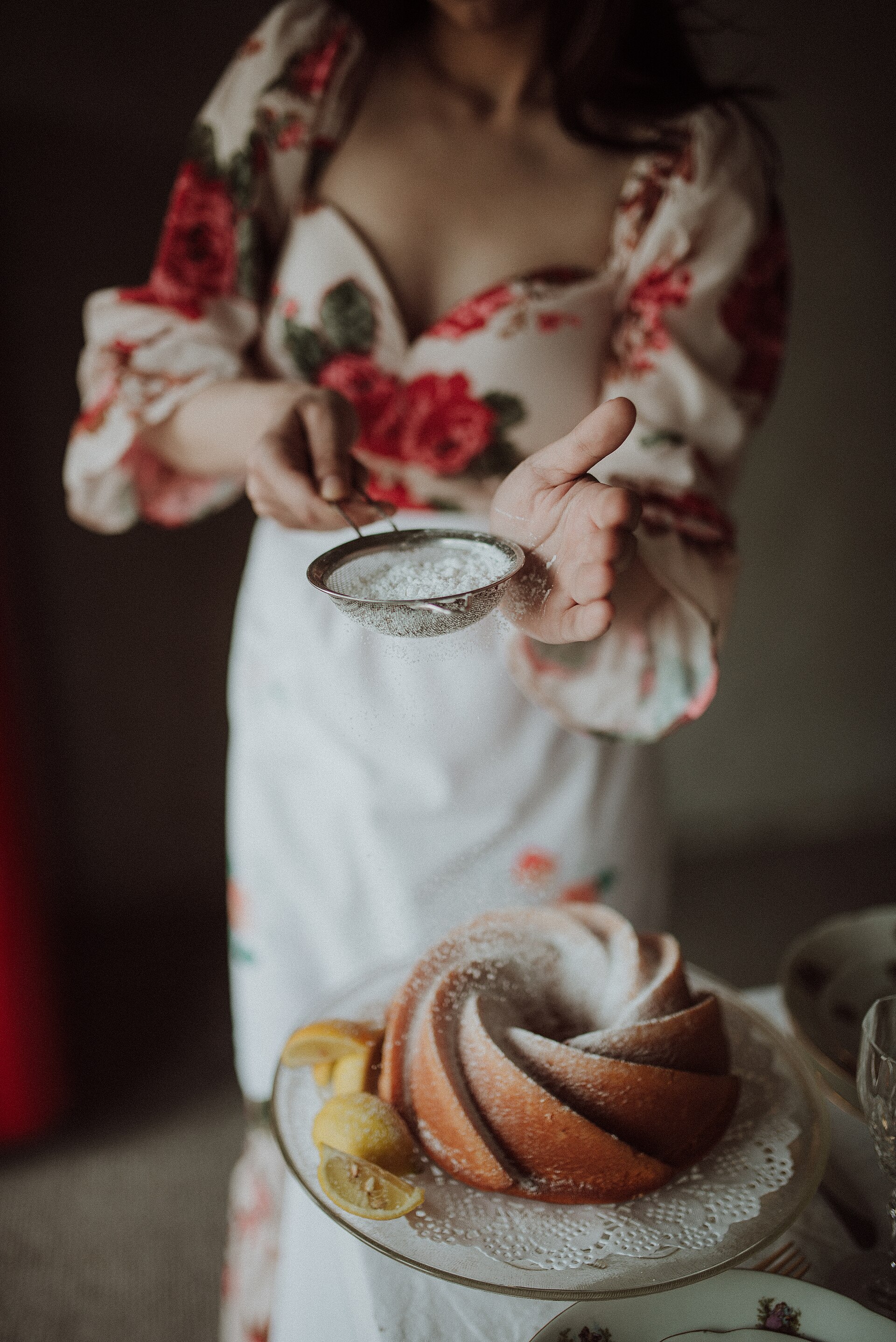 A freshly baked cake being dusted